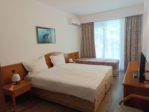 a hotel room with a bed and a window at Hotel Tourist - Metropol Lake Resort in Ohrid