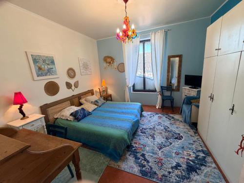 a bedroom with a bed and a table and a desk at La Vigneronne in Maureilhan-et-Raméjan