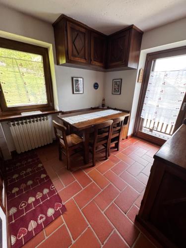 a kitchen with a table and chairs and a window at Maison Gerbore in La Salle