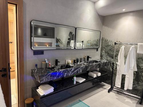 a bathroom with a sink and a mirror at VILLA Noor Atlas in Aghmat