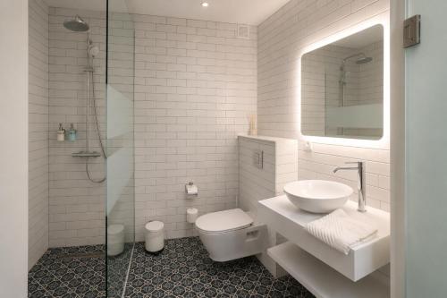 a bathroom with a toilet and a sink and a shower at Teracite in Varna City