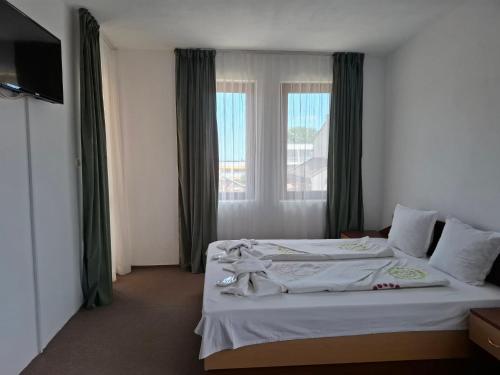 a hotel room with a bed and a window at Ivet Guest Rooms - Obzor in Obzor