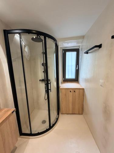 a walk in shower in a bathroom with a window at Encanto Griego in Chios