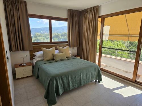 a bedroom with a bed and a large window at Santo Re Olive Retreat in Petrizzi