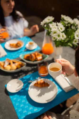 a blue table with plates of food and drinks at Residence San Marco Suites&Apartments Alassio in Alassio