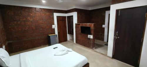 a room with a bed and a tv in it at Hotel Casa viora at swimming pool in Calangute