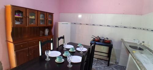 a kitchen with a table with plates and glasses on it at CasaLima in Bragança