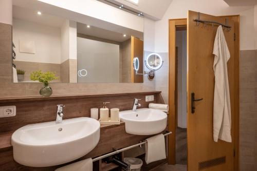 a bathroom with a white sink and a mirror at Apartment Anita in Westendorf