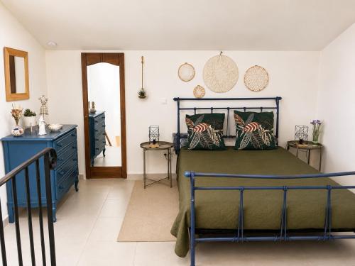 a bedroom with a bed and a blue dresser at L'oléastre en Luberon 2 in Grambois