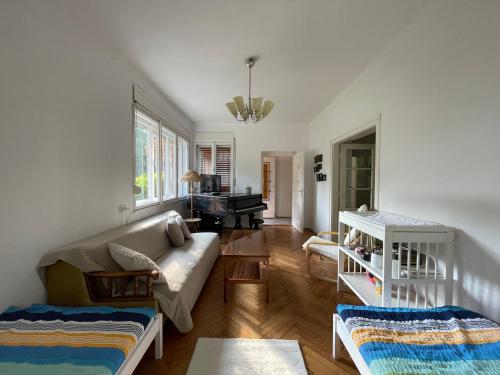 a living room with a couch and a piano at Zongorás Apartman in Balatonalmádi