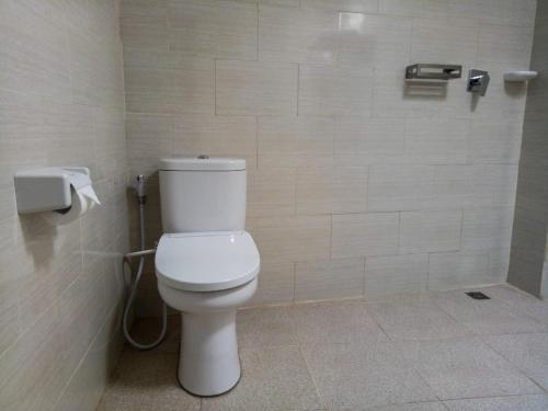 a bathroom with a white toilet in a stall at The Ambara Bali in Canggu