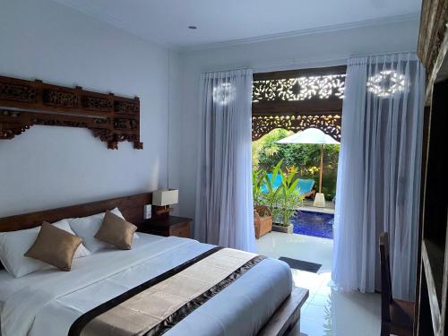 a bedroom with a bed and a large window at The Ambara Bali in Canggu