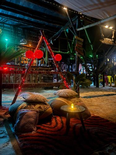 a room with a bed and a table with red lanterns at Tipiland baru la casa del mono in Playa Blanca