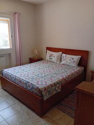 a bedroom with a bed in a room with a window at Paradise Days in Sfax