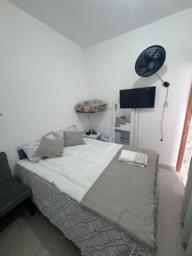 a bedroom with a large bed and a lamp at Ebeneze in Nova Friburgo