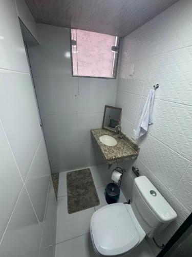 a small bathroom with a toilet and a sink at Ebeneze in Nova Friburgo