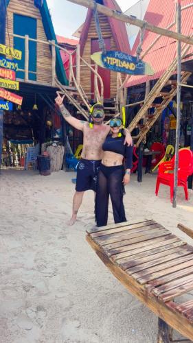 two people are standing on the beach at Tipiland baru la casa del mono in Playa Blanca