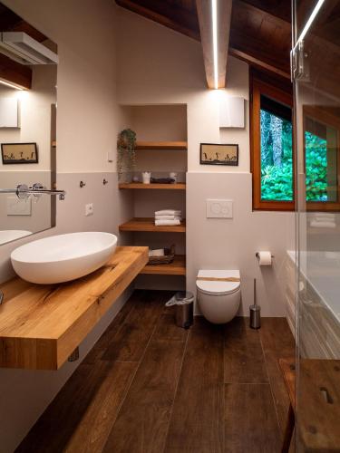a bathroom with a white tub and a toilet at Villa Zanotti in Cannero Riviera