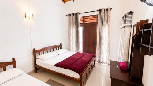 a bedroom with a bed and a window at Eighty seven guest and restaurant in Badulla