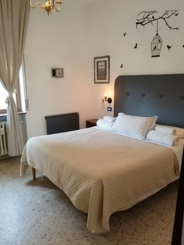 a bedroom with a large bed with a tree on the wall at Le stanze di Bruno in Pescara