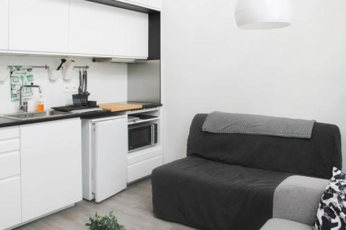 a small kitchen with a chair in a room at Stunning Bright Duplex in Saint-Ouen