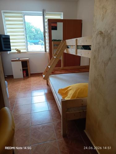 a bedroom with two bunk beds and a window at Studioul vacanțelor din Saturn 2 in Saturn