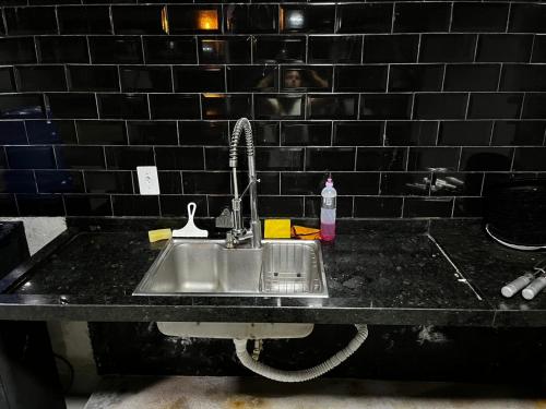 a kitchen sink with a faucet on a counter at Ks Espaço in Rondonópolis