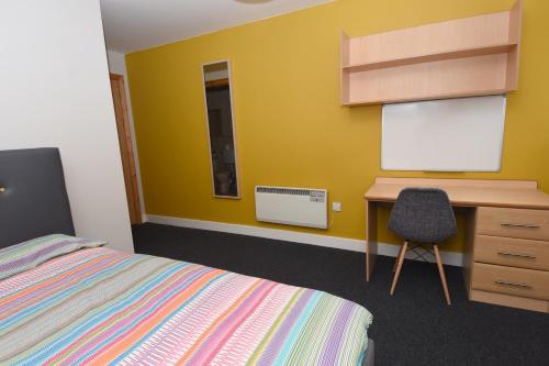 a bedroom with a bed and a desk and a chalkboard at Steelworks at Copley Court in Cork