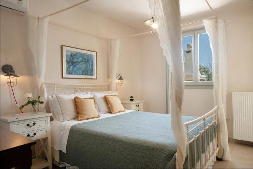 a bedroom with a bed and a window at Parasporos Villa - Private Pool - Beach Access in Parasporos