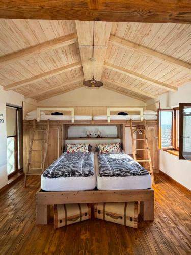 two beds in a room with two bunk beds at Agriturismo Fruske in Aurisina