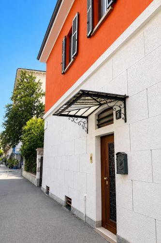 an orange and white building with a brown door at Rainbow District Mood Villa in Milan