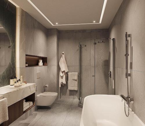a bathroom with a shower and a toilet and a sink at ZUMMA Hotel Almaty in Almaty