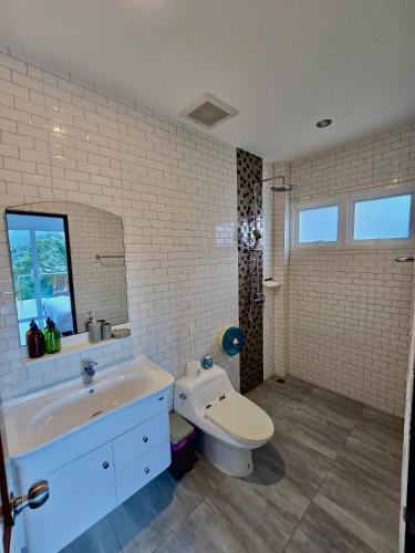 a bathroom with a toilet and a sink at Keya Mountain View Pool Villa Samui in Ban Thung