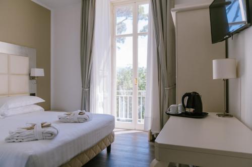 a hotel room with two beds and a television at Grand Hotel Telese in Telese