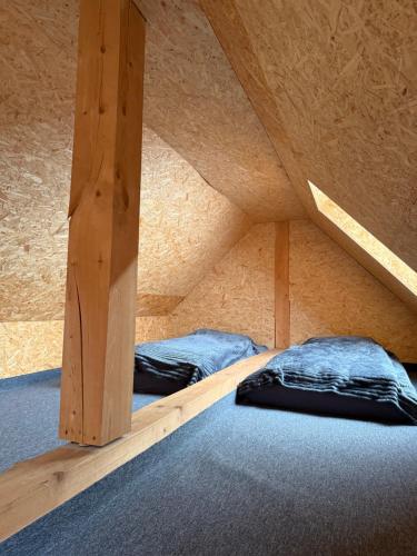 a room with two bunk beds in a attic at Apartmány u Anety in Mladé Buky
