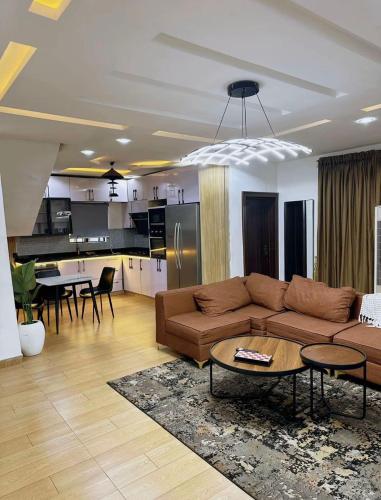 a living room with a couch and a table at North Unit in Asaba