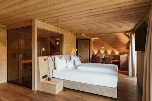 a bedroom with a large white bed in a room at Hotel Spielmann 4s in Ehrwald