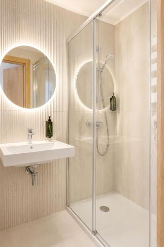 a bathroom with a shower and a sink at Szarotka Łeba - nowe domki blisko plaży in Łeba