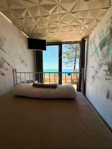 a bedroom with a bed with a view of the ocean at AZURA one in Varna City