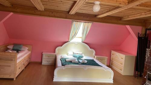 a bedroom with a white bed and pink walls at FreiNestWaldviertel in Hoheneich