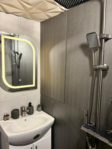 a bathroom with a sink and a mirror at AZURA one in Varna City