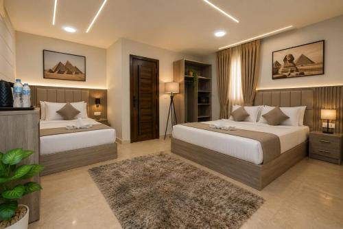 a bedroom with two beds and a rug at New Gardenia Pyramids - Rooftop in Cairo