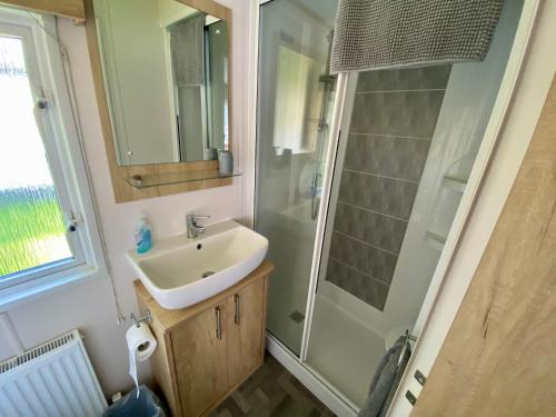 a bathroom with a sink and a shower at Debran Lodge in Angus