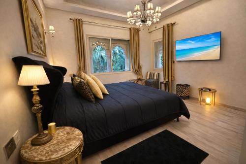 a bedroom with a bed and a couch at Barthélemy Guest House in Marrakesh