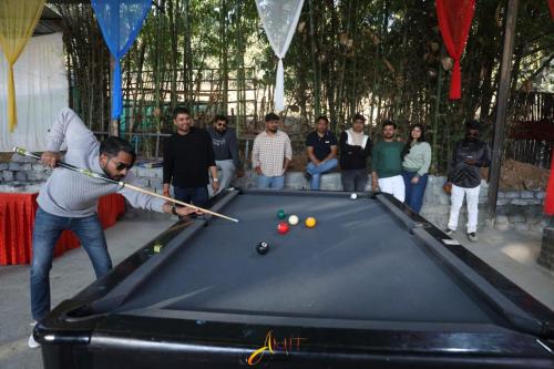 a man playing billiards with a pool table at Mount Magica - Refined By Nature in Rānchī