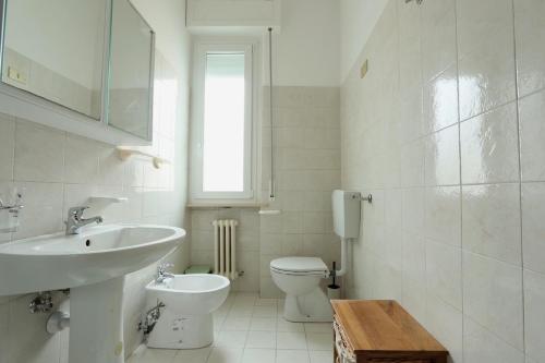 a white bathroom with a sink and a toilet at Bilocale a 500m dal mare in Giulianova