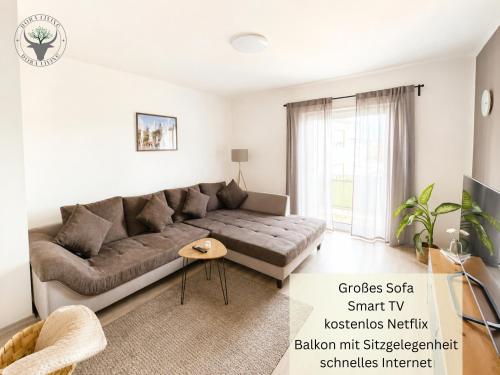 a living room with a couch and a table at Stierpartment am Pfälzer Wald nähe Outlet Center Zweibrücken in Pirmasens