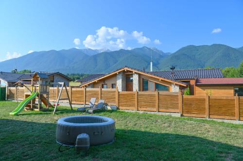 a backyard with a fire pit and a house at Villa Raphael w Jacuzzi near Pirin Golf Resort in Bansko