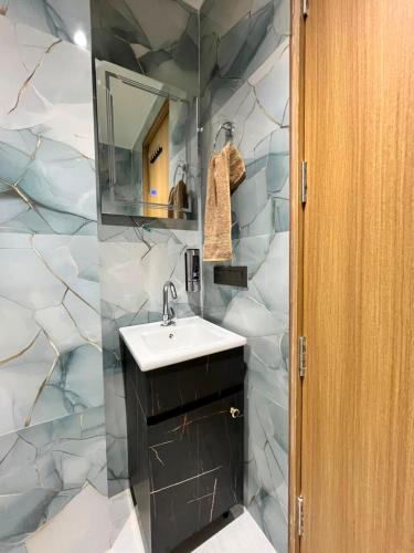 a bathroom with a sink and a mirror at Atithi in Hisār