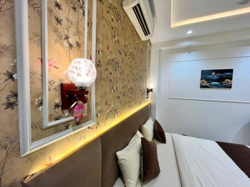 a hotel room with a bed and a mirror at Atithi in Hisār